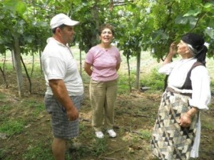 Prend in the grape yard with his mother (opposite) and our project manager, Margherita Cuni