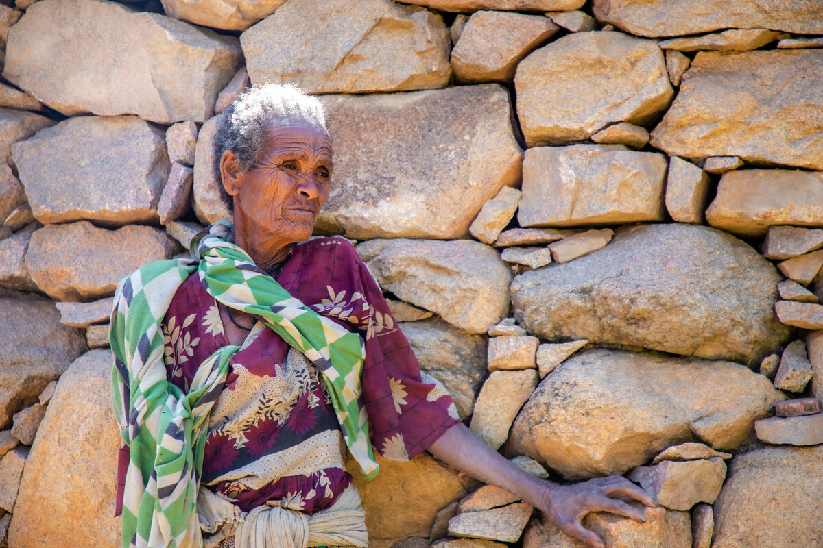 Tadelech Gebrihet ha vissuto per 60 dei suoi 70 anni sulle montagne del Tigray. Spiega come le conseguenze del conflitto si ripercuotano su sfollamenti diffusi, grave insicurezza alimentare e mancanza di accesso ai servizi essenziali, gettando un'ombra particolarmente pesante su questa vasta regione. Credit: Zerubabel Tore/Oxfam